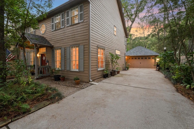 property exterior at dusk with an outbuilding and a garage