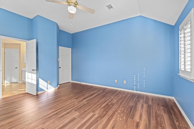 unfurnished bedroom featuring hardwood / wood-style flooring, vaulted ceiling, and ceiling fan