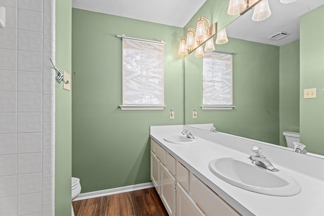 bathroom with hardwood / wood-style flooring, vanity, and toilet