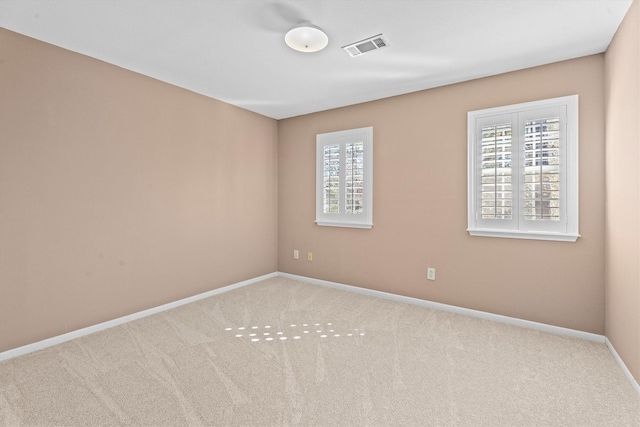 unfurnished room with light colored carpet