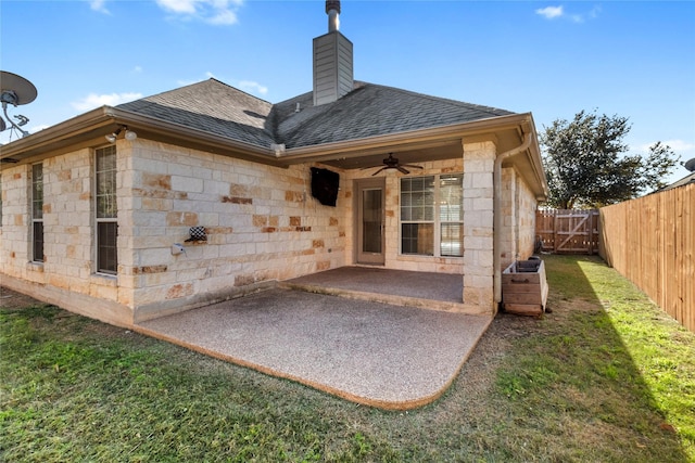 back of house featuring ceiling fan, a lawn, and a patio