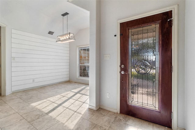 entrance foyer with lofted ceiling and an inviting chandelier