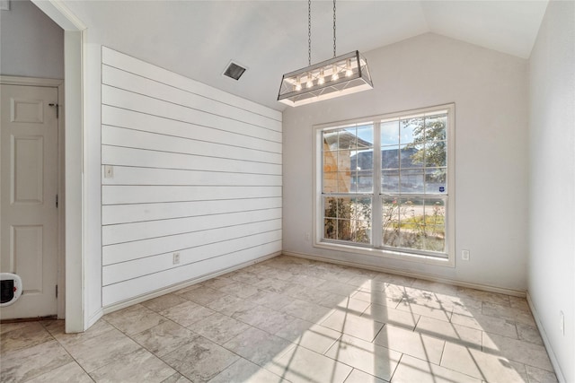 unfurnished dining area with vaulted ceiling