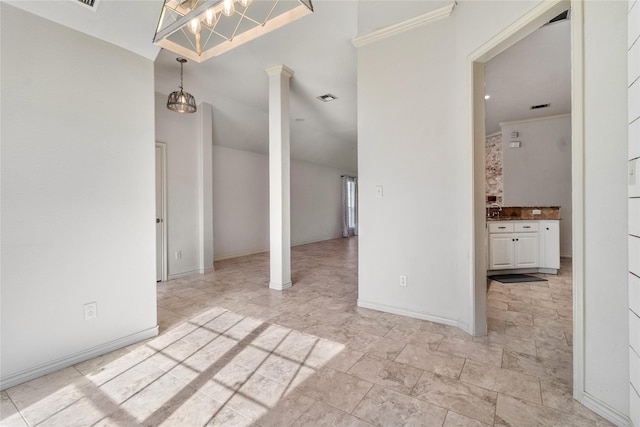 interior space with decorative columns, sink, crown molding, and a notable chandelier