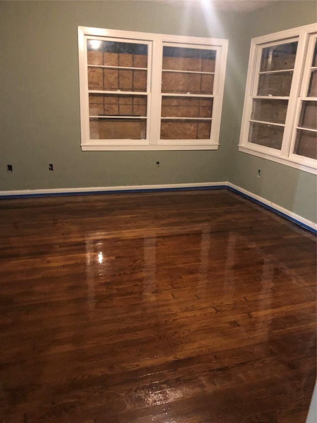 empty room with dark hardwood / wood-style floors