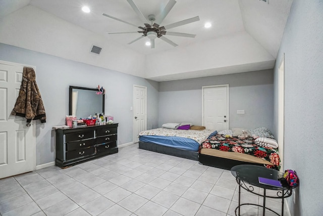 bedroom featuring ceiling fan, light tile patterned floors, a tray ceiling, and vaulted ceiling