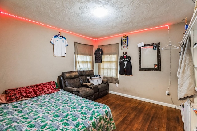 bedroom featuring a textured ceiling and dark wood-type flooring