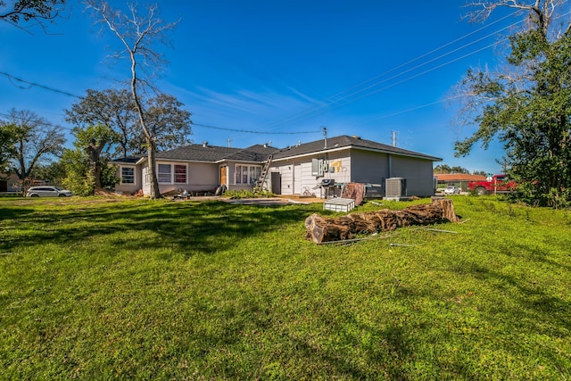 rear view of house with a yard