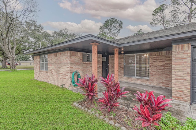 exterior space with covered porch and a front yard