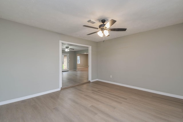 spare room featuring ceiling fan and light hardwood / wood-style flooring