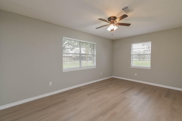 unfurnished room featuring ceiling fan and light hardwood / wood-style flooring