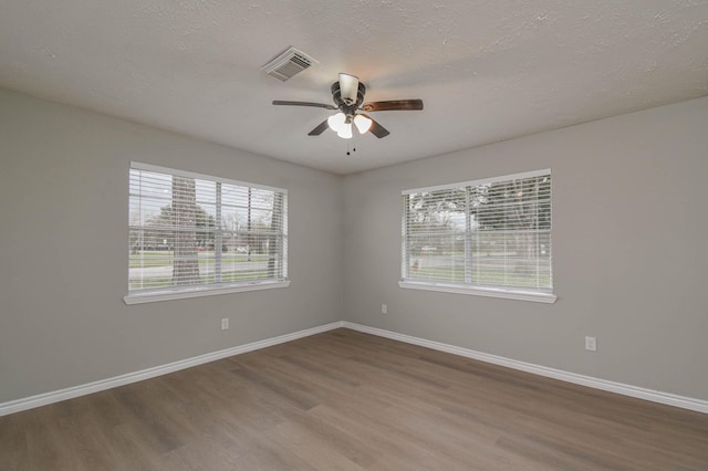 unfurnished room featuring hardwood / wood-style flooring, a textured ceiling, and ceiling fan