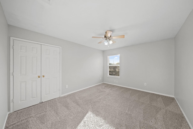 unfurnished bedroom with ceiling fan, a closet, and carpet