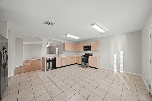 kitchen featuring ceiling fan, light tile patterned floors, light brown cabinets, and black appliances