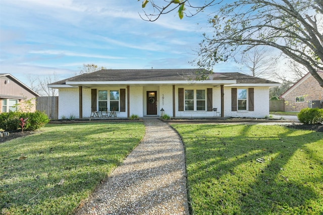 ranch-style house with a front lawn and covered porch