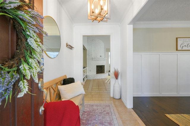 interior space with an inviting chandelier, crown molding, and a fireplace