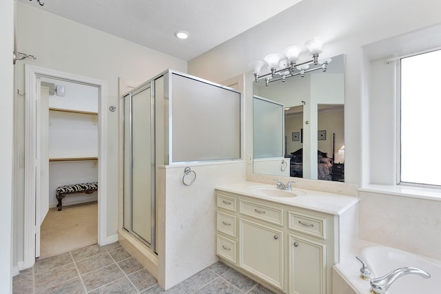 bathroom featuring vanity and shower with separate bathtub