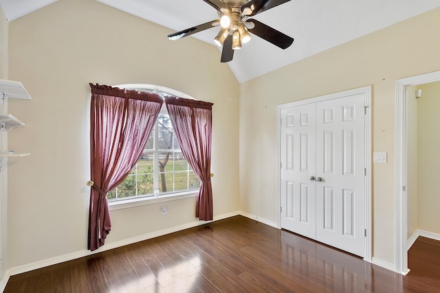 unfurnished bedroom featuring ceiling fan, vaulted ceiling, dark hardwood / wood-style floors, and a closet