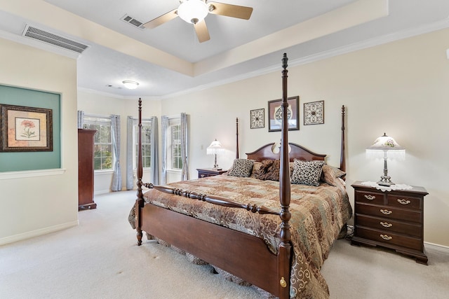 bedroom featuring light carpet, ceiling fan, ornamental molding, and a raised ceiling