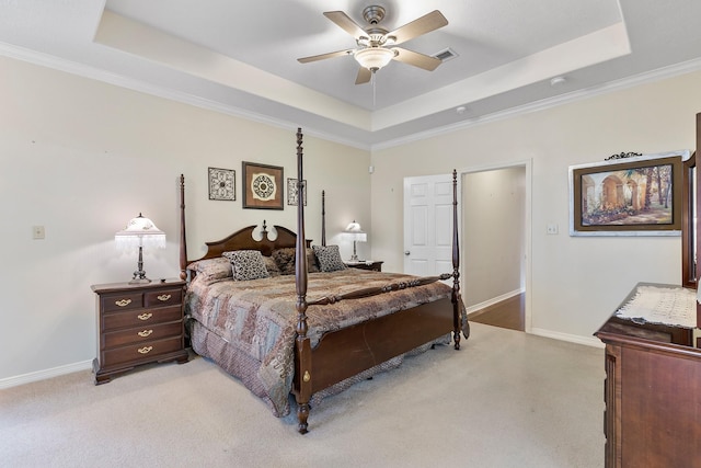 bedroom featuring a raised ceiling, ceiling fan, and light carpet