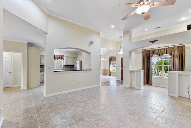 unfurnished living room with ceiling fan and crown molding