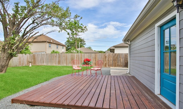 wooden deck featuring a lawn