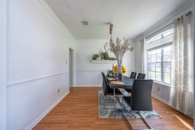 dining room featuring ornamental molding and hardwood / wood-style floors