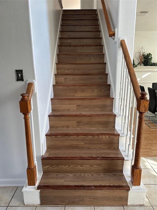 stairway featuring tile patterned floors