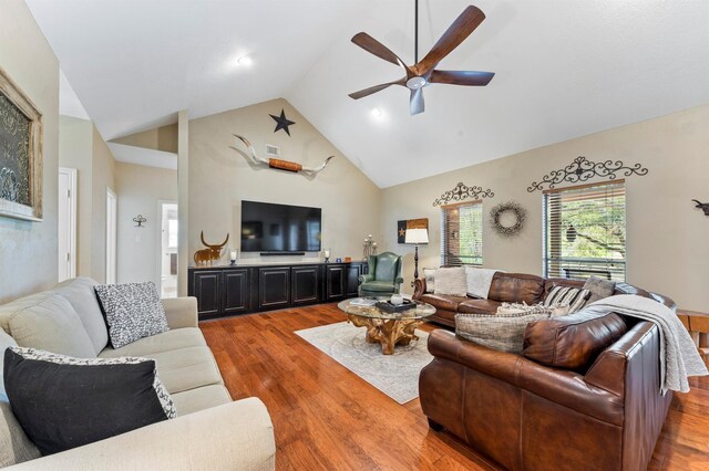 living room with vaulted ceiling, ceiling fan, and hardwood / wood-style flooring