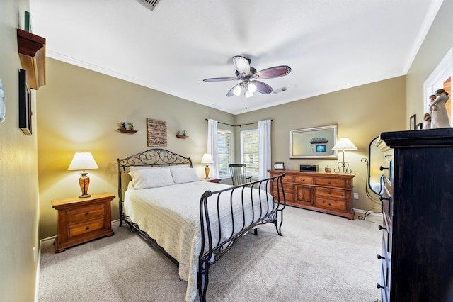 bedroom featuring light carpet, ornamental molding, and ceiling fan