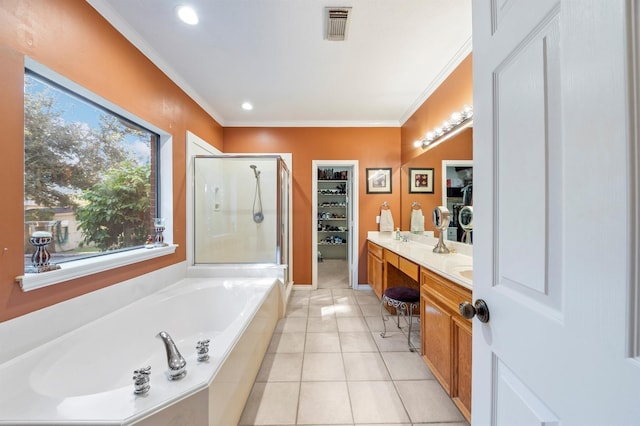 bathroom featuring ornamental molding, shower with separate bathtub, tile patterned floors, and vanity