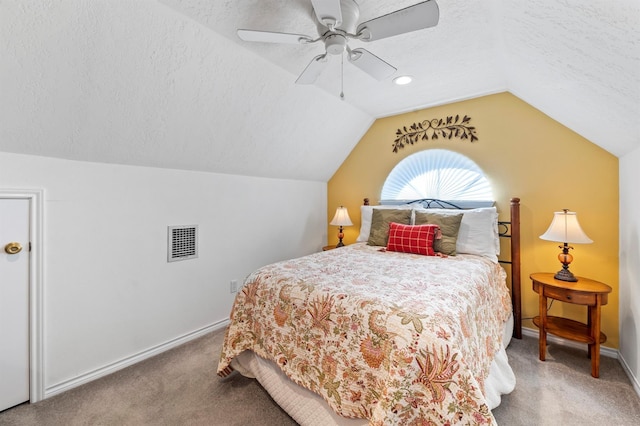 carpeted bedroom featuring ceiling fan, a textured ceiling, and lofted ceiling