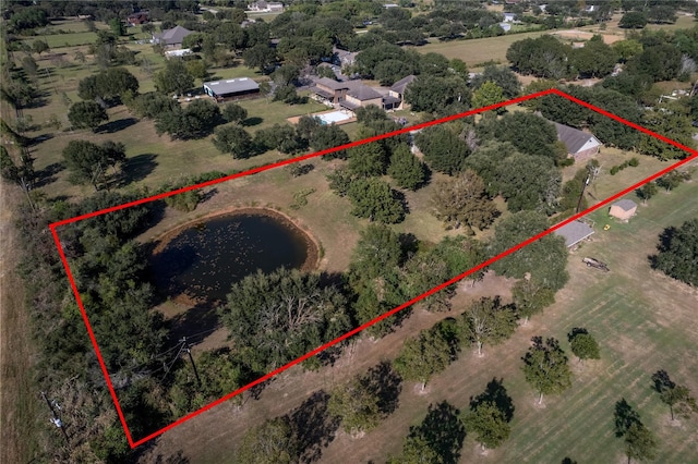 birds eye view of property featuring a rural view and a water view