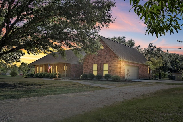 view of front of home featuring a garage and a yard