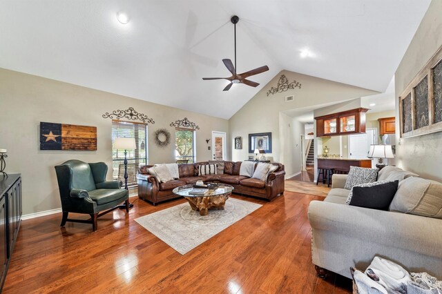 living room featuring ceiling fan, dark hardwood / wood-style flooring, and high vaulted ceiling