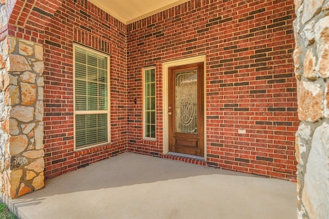 doorway to property with a patio