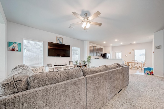 living room featuring ceiling fan, a healthy amount of sunlight, and carpet