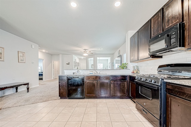 kitchen featuring black appliances, light carpet, sink, ceiling fan, and dark brown cabinets