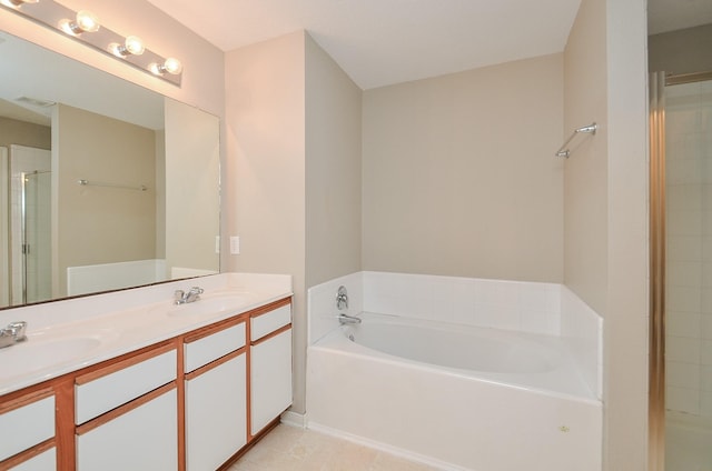 bathroom with tile patterned flooring, vanity, and separate shower and tub