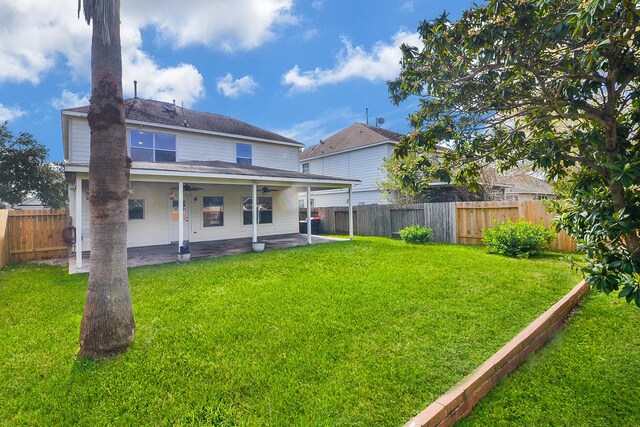 rear view of house with a lawn and a patio area