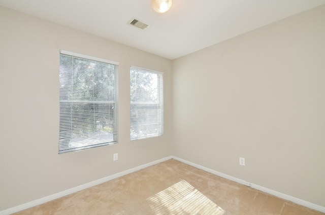 unfurnished room with light colored carpet