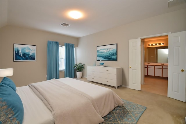 bedroom with light colored carpet and vaulted ceiling