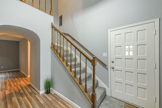 entryway with a high ceiling and hardwood / wood-style flooring