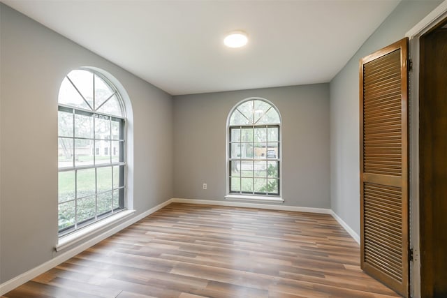 unfurnished room with wood-type flooring