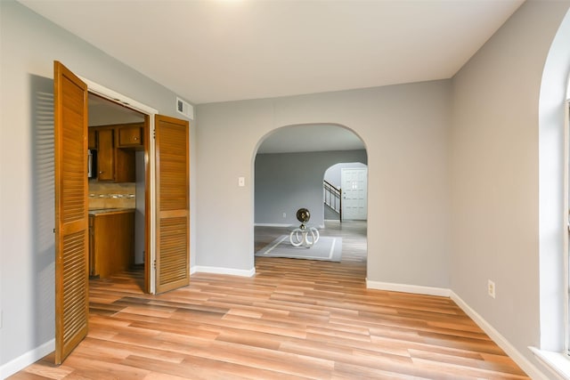 spare room with light hardwood / wood-style floors