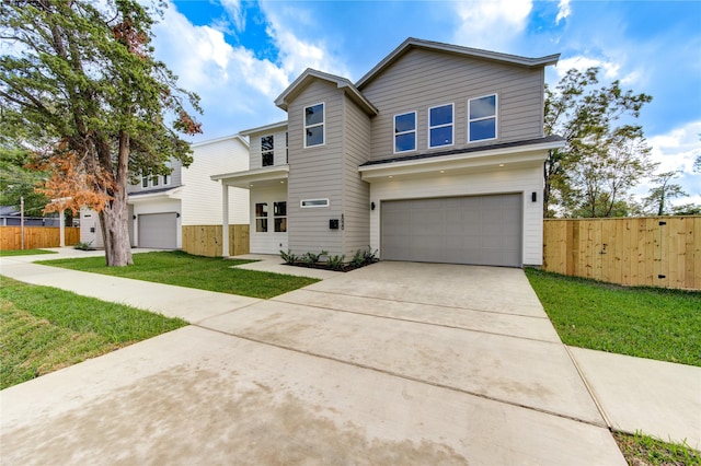 view of front facade with a front yard and a garage