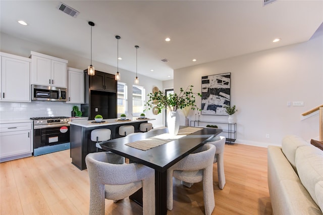 dining area with light hardwood / wood-style flooring