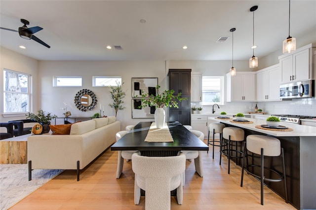 dining area featuring ceiling fan and light hardwood / wood-style flooring