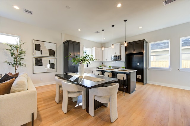 dining area featuring sink and light hardwood / wood-style flooring