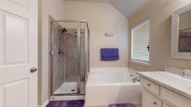 bathroom featuring lofted ceiling, independent shower and bath, and vanity